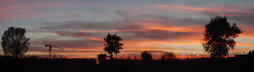 Fototapeta na wymiar a wide angle view of an orange cloudy sunset