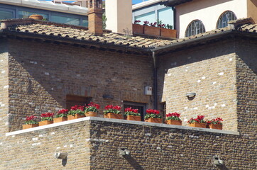 brick balcony with vase and flowers