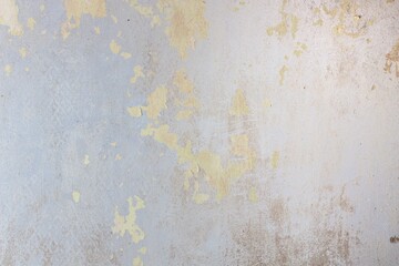Photo of an unpainted wall with pieces of old paint, texture and patterns