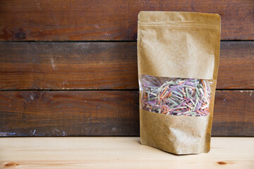 A pack of veggie noodles, in front of a wooden backdrop