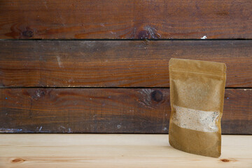 A pack of instant soup (tarhana) , in front of a wooden backdrop