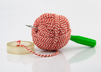 Bookbinding or paper sewing tools on white background. A bundle of rope and awls use for stitching...