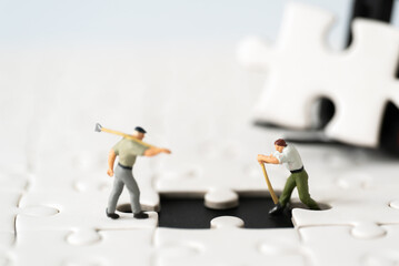 Miniature Inspector or Engineer Worker Labor is checking fixing missing Jigsaw Puzzle Site Project...