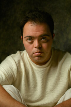 Portrait of young man with Down Syndrome looking into the camera