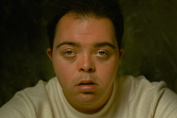 Portrait of young man with Down Syndrome looking into the camera
