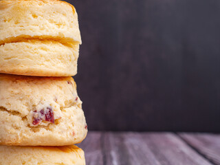 Scones traditional English delicious fresh homemade with dark vintage wall background. Close-up photo. Dessert, beverage, and relaxation concept