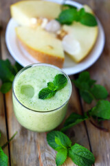 Smoothie melon mint in glasses on a wooden surface. Refreshing detox summer drink.
