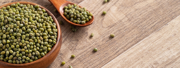 Close up of raw mung bean on wooden table background.