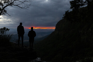 silhouette of people on a mountain top