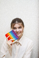 cheerful girl plays pop it. antistress, simple-dimple, pop-it