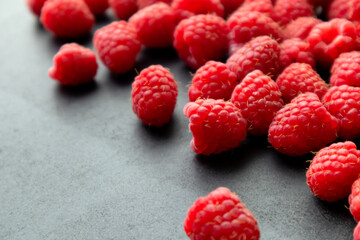 Fresh and sweet raspberry in a dark background. Selective focus.