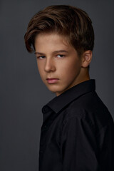 Obraz premium Portrait of a young teenage guy in black clothes 