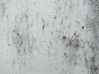 old and white concrete wall with which paint peels off.