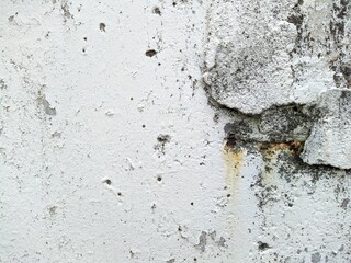 old and white concrete wall with which paint peels off.
