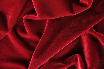 abstract texture of draped red velvet background. eautiful textile backdrop. Close-up. Top view