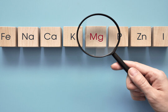 Wooden cubes with inscriptions of vitamins and macronutrients. Choosing magnesium from other useful substances
