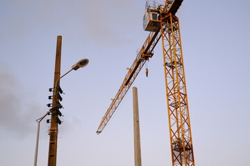 A yellow crane on a small construction site near the coast. Sainte-Marguerite, France, the 10th august 2021.