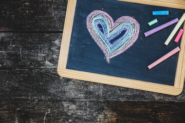 blackboard with painted heart on it, lgbt colours used with chalk