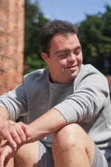 Young man with Down Syndrome in active wear looking to the side