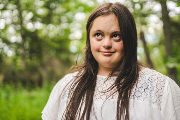 Portrait of trisomy adult outside having fun