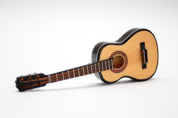 Obraz na płótnie Canvas Acoustic Guitar Small Model Toy on white background