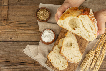 Male hands are holding freshly baked bread