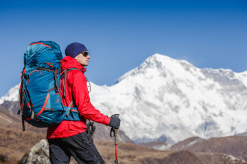 Fototapeta na wymiar Active hiker hiking, enjoying the view, looking at Himalaya mountains landscape. Travel sport lifestyle concept