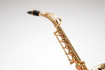 Model of toy bronze saxophone on white background