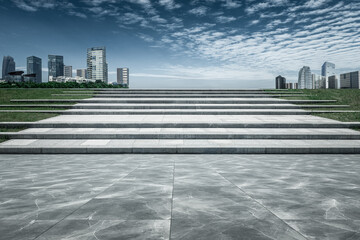  The city buildings behind the stone steps under the clear sky