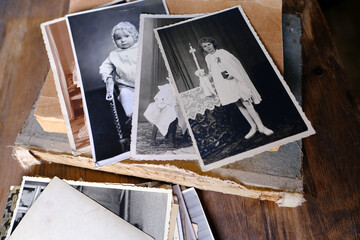 stack of vintage photos, retro photography of 1940-1950 on wooden table, old books, concept of...