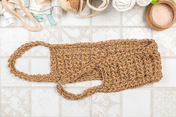 natural bathroom accessories. bath sponges, washcloths, soap and towels on a light background. hygiene cleanliness concept