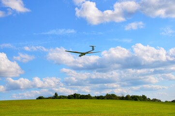 Sailplane, glider in the sky, in landing process. Beautiful natural background 