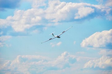 airplane in the white clouds blue sky