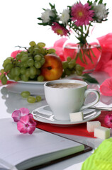 Morning breakfast with coffee, flowers and fruits on a light background