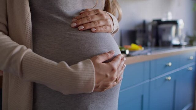 Close up of pregnant woman touching the belly. Shot with RED helium camera in 8K