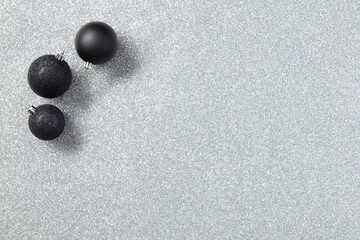 Black Christmas toys or decor on a gray background with copy space