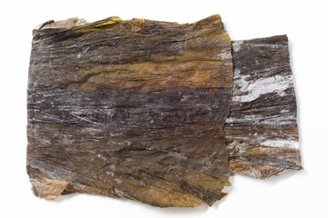 Big  dried nori seaweed laminaria sheets. Nori seaweed dried in flat sheets. Wrinkled brown background. For making sushi, rolls and other dishes. Background for asian food. Crispy dried seaweed.