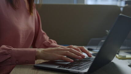 Businesswoman hands typing on laptop. Executive in medical mask using computer