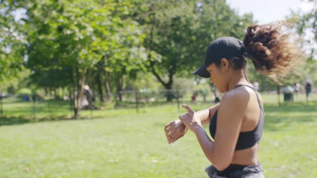 Profile shot of young healthy woman jogging in the park, in slow motion