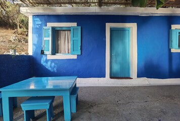 restaurant fish tavern in sunset by the sea blue windows blue steps chairs and tables