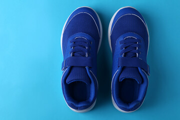 blue Kids modern shoes isolated on blue background with copy space on the right