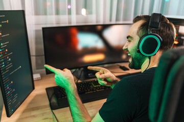 Happy young man gamer streamer in headphones