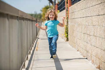 Obraz na płótnie Canvas Childhood play. Happy boy have fun running on promenade. Outdoor play. Summer activities
