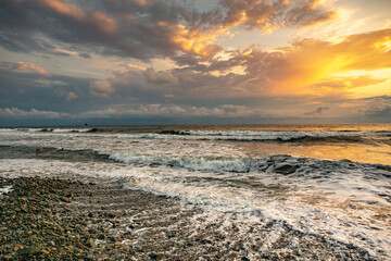 Charming sunset on the black sea beach in Georgia.