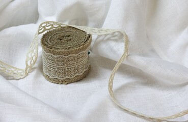 Hemp ribbon made of nettle and flax on a white fabric.Hobby material.