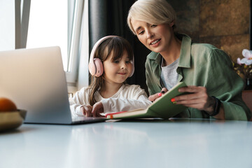 Mother helping her daughter with her homework