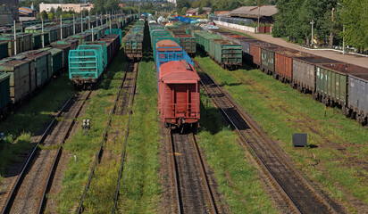 Freight cars of various purposes on the rails.