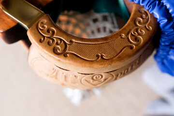 A billiard pocket. Patterned leather trim. No people, blurred background