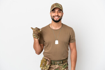 Young arab soldier man isolated on white background pointing to the side to present a product