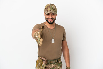 Young arab soldier man isolated on white background shaking hands for closing a good deal